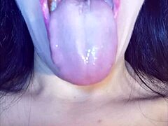 Home video of a young amateur's mouth play and throat fetish
