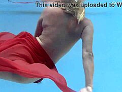 Blonde milf Emily Ross strips down in the pool
